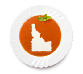 Plate tomato soup with cream in the shape of Idaho.(series)