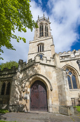 Fototapeta na wymiar Old medieval english church with clock tower
