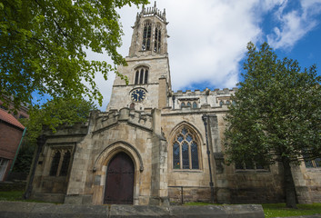 Fototapeta na wymiar Old medieval english church with clock tower