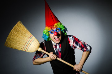 Funny clown with the broom