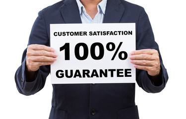 Business man hand holding paper customer satisfaction 100% guara