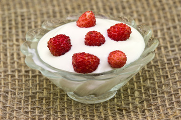 Saucer of cream with strawberries