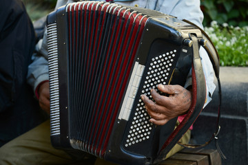 Man at street playing accordion