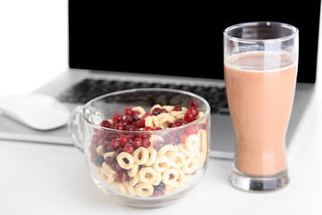 Composition with laptop and healthy breakfast, isolated on