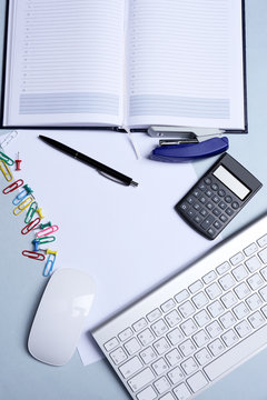 Office table with stationery accessories, keyboard and paper,
