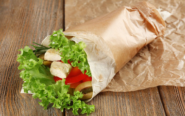 Veggie wrap filled with chicken and fresh vegetables