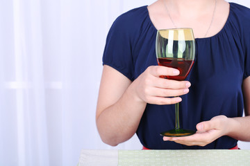 Young woman with glass of red wine