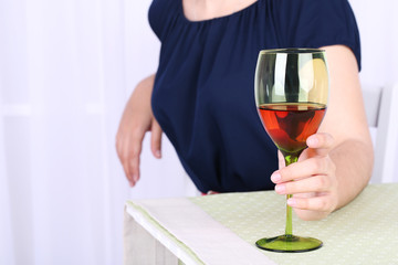 Young woman with glass of red wine