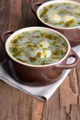 Delicious green soup with sorrel on table close-up