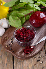Grated beetroots in bowl on table close-up
