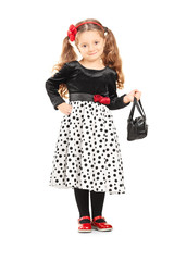 Cute little girl holding a purse