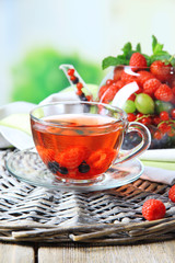 Fruit red tea with wild berries in glass cup,