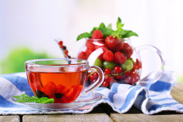 Fruit red tea with wild berries in glass cup,