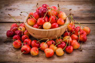 Rainier Cherries in a bowl on wooden background