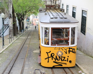 Yellow tram with graffity in lisbon