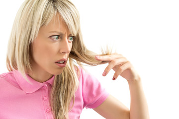 Woman looking to her hairs' splitting ends