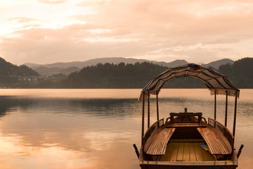 Touring boat on famous Lake Bled, Slovenia at sunset