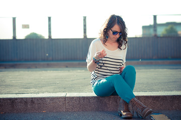 Fototapeta premium young beautiful brunette woman with smart phone