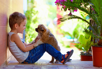 excited boy playing with beloved puppy