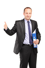 Businessman holding a folder and giving thumb up