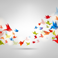 Origami paper bird on abstract background