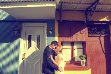 Bride kissing groom standing at the table