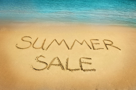 Summer sale letters on sand