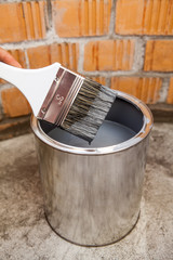 Stained grey color paint brush over can