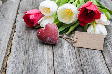 fresh tulips and red heart with a tag