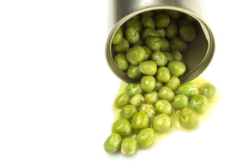 Green peas in a tin can over white background