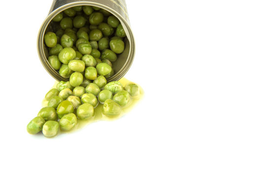 Green peas in a tin can over white background
