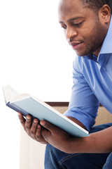 handsome black man reading book.