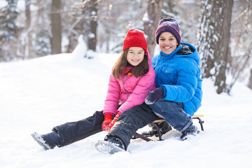 Fototapeta na wymiar two children prepared to slide from hill.