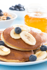 pancakes with banana, honey and blueberry, close-up