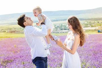 Fototapeta na wymiar Happy family having fun in lavender field
