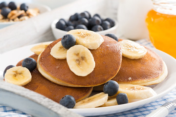 pancakes with banana, honey and fresh blueberries for breakfast