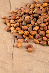 pine nuts on wooden surface