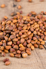 pine nuts on wooden surface
