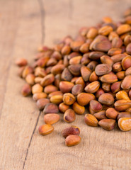 pine nuts on wooden surface