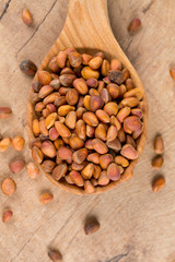 pine nuts on wooden surface