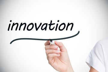 Businesswoman writing the word innovation