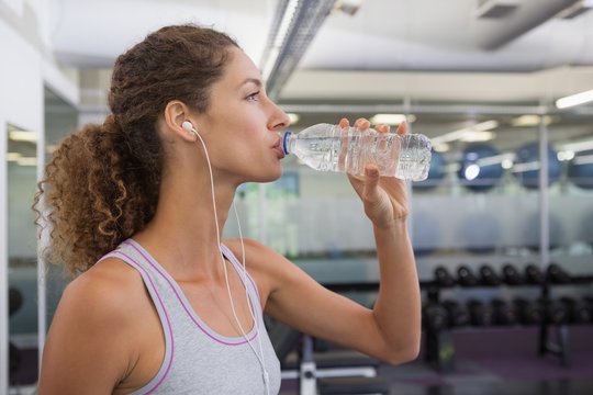 Fit Woman Drinking From Water Bottle