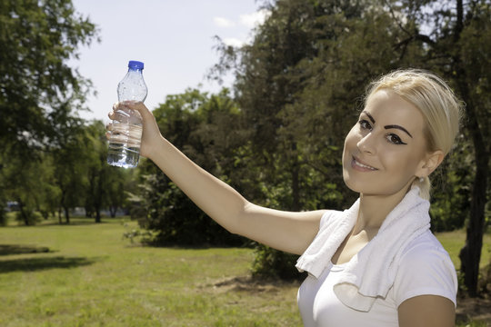 young attractive woman holding a bottle of water