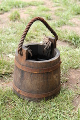A Medieval Style Wooden Bucket with a Rope Handle.