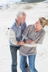 Attractive couple messing about on the beach