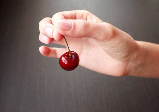 Fresh cherry in woman hand