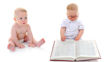 Little smart boy reads a big book.