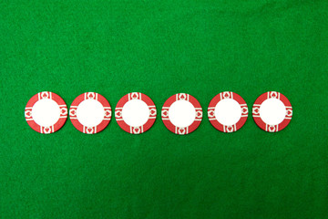 Five chips on green casino table