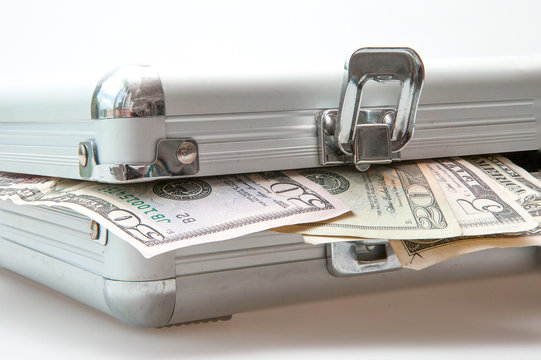 Silver suitcase with Dollar notes showing