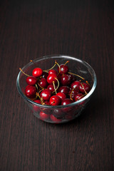 Fresh cherries in a bowl on table